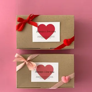 Kraft paper gift boxes set with ribbons and heart cards, ideal for romantic occasions and packaging.