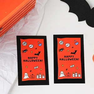 Halloween greeting cards detail shot, featuring cute ghost and pumpkin patterns with text.