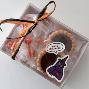 Halloween theme gift box packaging with decorative dialogue stickers and delicious candy treats.
