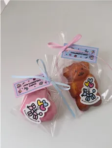 Children's day gift bags with cute cartoon tags, bear cakes and ribbons for student party favors.