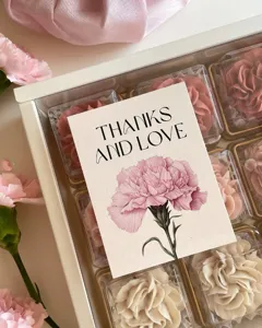 Detail shot of Mother's Day carnation greeting card with thank you message and floral box.