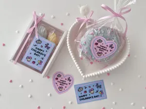 Close-up detail of Children's Day gift cards and stickers with cute cartoon robot designs.