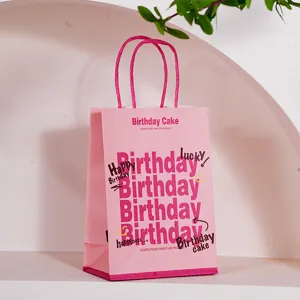 Pink paper gift bag with birthday theme design, elegant handles for party packaging.