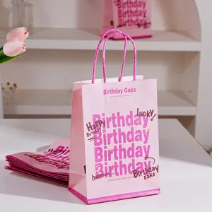 Pink birthday paper gift bag with cute letter prints and twisted handles, perfect for party.
