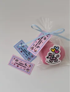 Cute cartoon children's day gift tags with transparent packaging bag and ribbon detail.