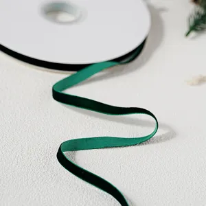 Dark green velvet ribbon roll for gift wrapping, Christmas DIY crafts and elegant packaging.
