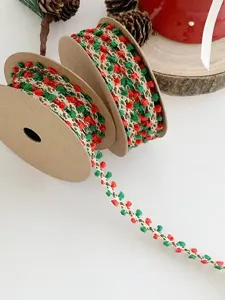 Christmas decorative ribbon detail view, red and green pom pom trim for DIY gift wrapping.