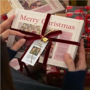 Christmas velvet ribbon gift wrapping set with golden bell and tag for holiday box decoration.