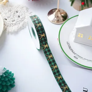 Christmas green plaid ribbon with gold reindeer for gift wrapping and holiday DIY crafts.