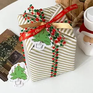 Christmas decorative ribbon gift wrapping string with pom poms for holiday present packaging.
