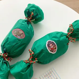 Christmas giant candy gift packaging with decorative pompom ribbons and festive stickers