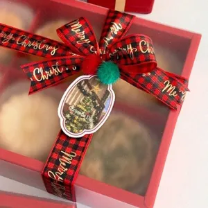 Christmas red and black plaid gift wrapping ribbon with gold printed festive text for holiday decor.