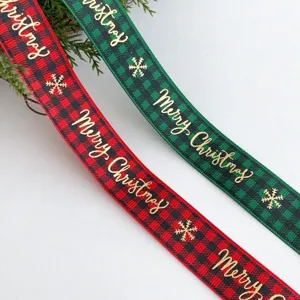 Red and green plaid Christmas ribbon with gold foil Merry Christmas and snowflake prints.