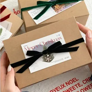 Christmas velvet ribbon gift box packaging set with decorative holiday cards and festive bows.