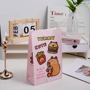 Detailed view of the pink cute cartoon gift paper bag featuring fun capybara and fast food prints.