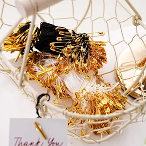 Black and white hang tag strings with gold safety pins for clothing labels and DIY crafts.