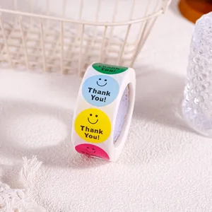 Rouleau d'autocollants colorés visage souriant remerciement pour emballage cadeau et loisirs.