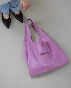 Detail shot of the purple soft leather tote shoulder bag, showcasing its large capacity and lazy style.