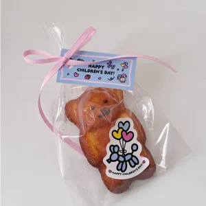 Cute cartoon bear cake gift bag with pink ribbon and happy children's day header card.