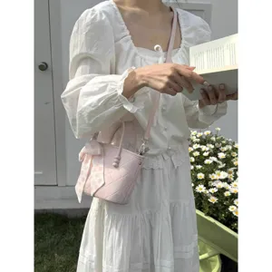 Sweet pink quilted bucket bag for women, stylish shoulder handbag with cute ribbon scarf.