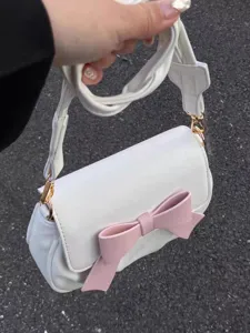 White shoulder bag detail showcasing cute pink bow and soft gathered cloud design.