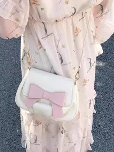 Cute white crossbody shoulder bag for women with a stylish big pink bow and soft pleated design.