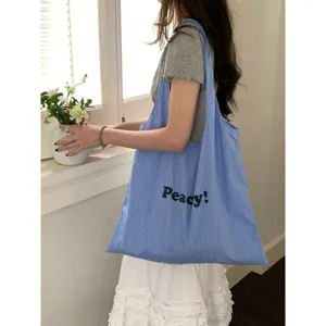 Detail view of the striped nylon tote bag in blue, showcasing casual everyday style.