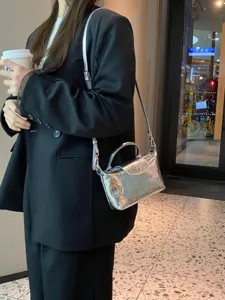 Silver metallic dumpling shoulder bag for women, trendy top handle crossbody bag for summer.
