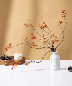 Artificial red maple leaf branch decoration with white vase for autumn home living room decor.