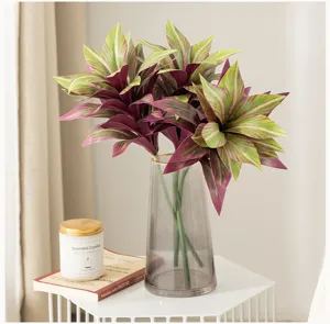 Artificial dracaena foliage in glass vase, elegant detail for indoor home decor and floral display.