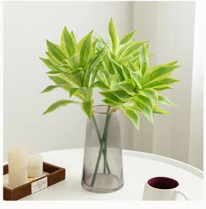 Artificial plant green leaves in glass vase detail view home decor interior aesthetic plant