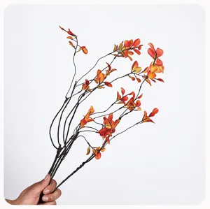 Detailed shot of artificial autumn maple branches with vibrant red and orange leaves for vase decor.