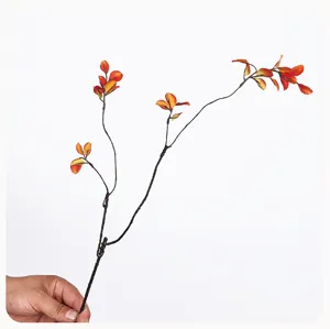 Artificial autumn maple leaf branch detail, fake plant stem for home vase arrangement.