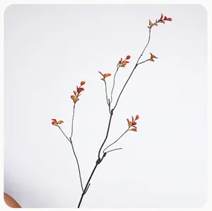 Close up of artificial maple leaf branch detail, autumn foliage decor for home vase arrangement.