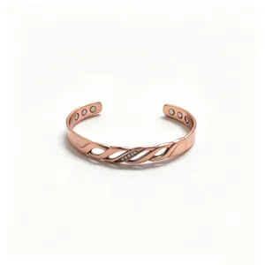 Detailed view of magnetic copper cuff bracelet with infinity twist design and cubic zirconia.