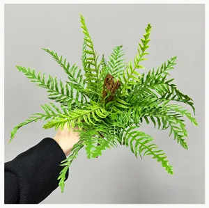 Artificial fern plant detail view, vibrant green fronds with realistic brown fiddlehead.