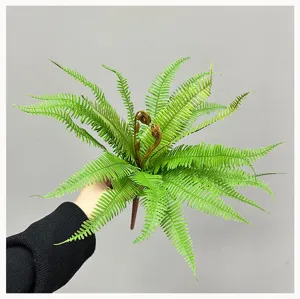 Artificial fern plant detail showing realistic green fronds and brown stem for home decor