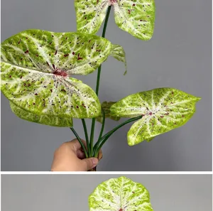 Vue détaillée de feuilles de caladium artificielles avec motif vert et rouge vif pour déco.