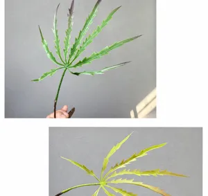 Détail de branche de feuille de plante artificielle, parfait pour la décoration intérieure verte.