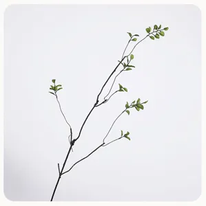Artificial green plant branch detail shot, realistic foliage stem for vase floral decor.