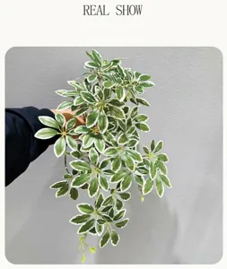 Detailed view of artificial hanging plant with variegated leaves for interior decoration.