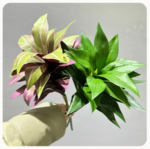 Artificial plant leaves detail shot, vibrant green and pink foliage for home floral decor.