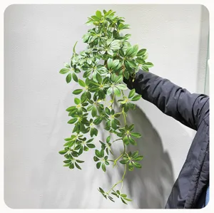 Artificial hanging plant detail, lush green foliage for wall decor and home interior styling.