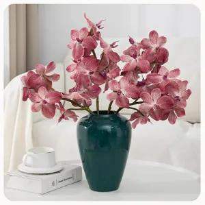 Artificial vanda orchid flowers in dark green ceramic vase for home decor and wedding arrangement