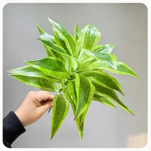 Artificial plant leaf detail, green variegated foliage branch for indoor home floral decor.