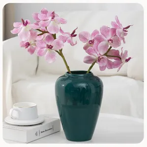 Artificial phalaenopsis orchids in dark green ceramic vase home decor floral arrangement