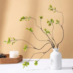 Minimalist artificial green plant branch in white ceramic vase home decor main product photo.