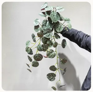 Detailed artificial hanging plant view showing mottled leaves and natural cascading vine design.