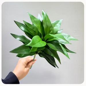 Artificial green plant leaf bouquet detail close-up, fake foliage stem for home decor.