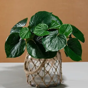 Artificial green plant potted ornament with rope-wrapped glass vase for home decor detail.